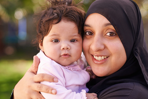 Afghan refugee mother holding her baby girl