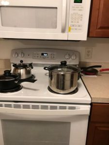 pots and tea kettle on a stove